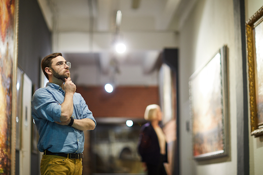 Portrait,Of,Pensive,Bearded,Man,Looking,At,Paintings,Standing,In